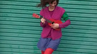 Dziewczyna grająca na czerwonym ukulele