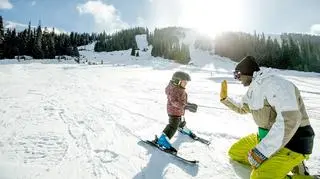 Dziecko uczy się jeździć na nartach 