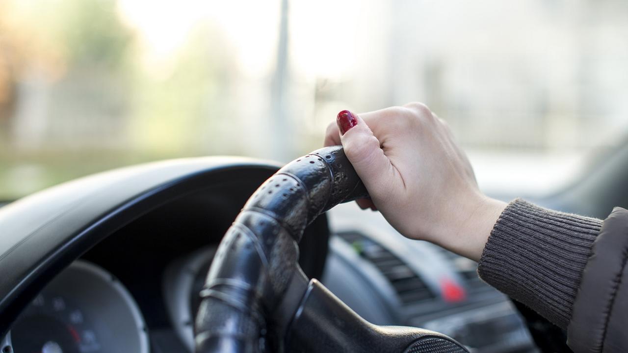 Kobiece dłonie na kierownicy w samochodzie